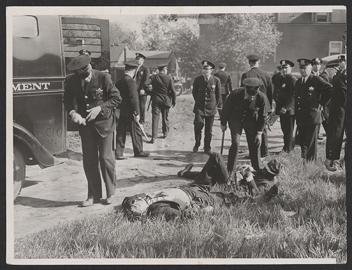 Police gather around injured striking workers